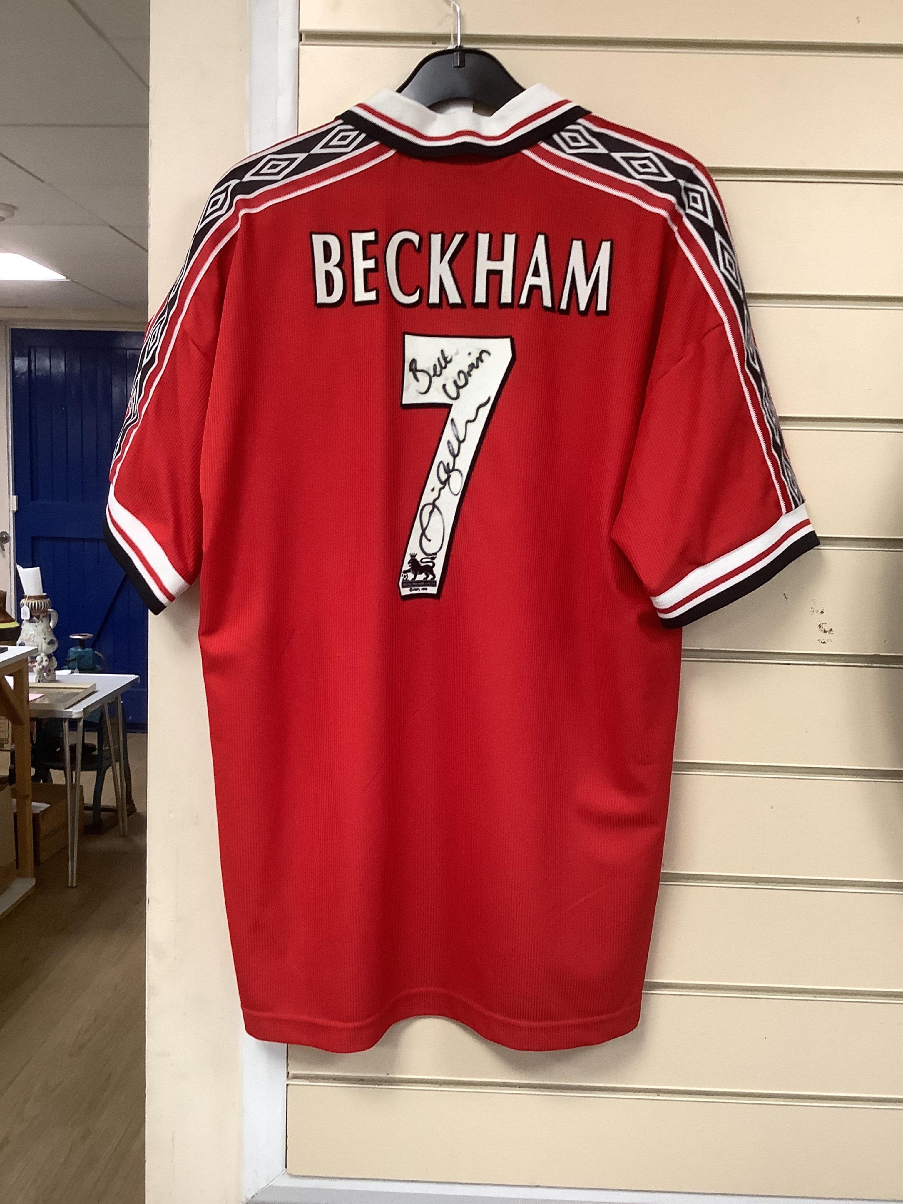 A Manchester United Umbro Sharp polo shirt, signed by David Beckham